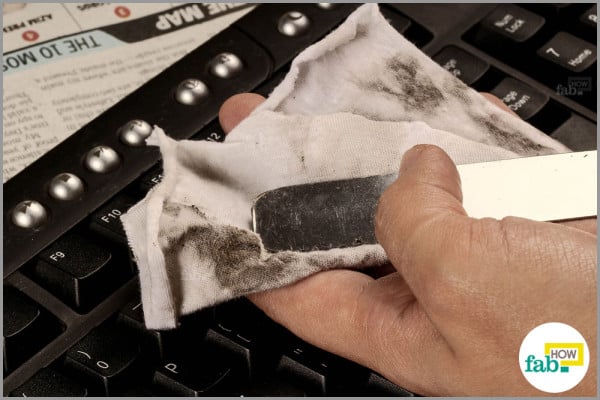 keyboard dirt caught using waxing knife and cloth
