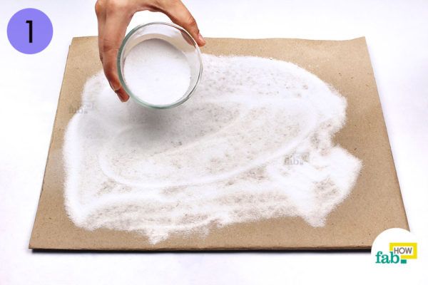 Spread salt over a sheet of brown paper