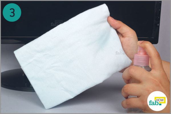 Spray some cleaning solution on lint free cloth