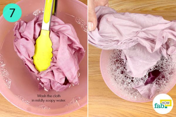 Wash the cloth in mildly soapy water
