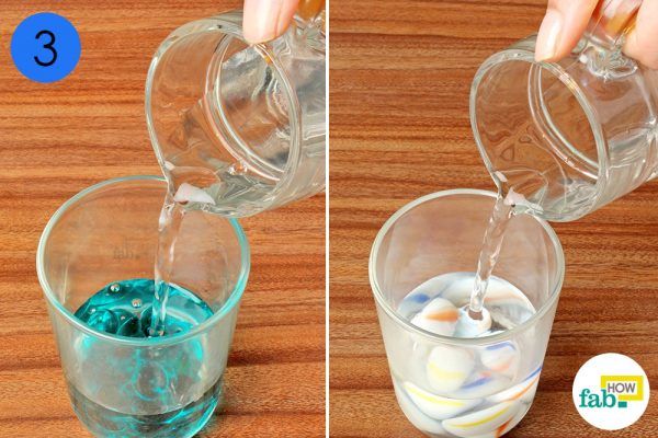 throw marbles and water into a glass cup