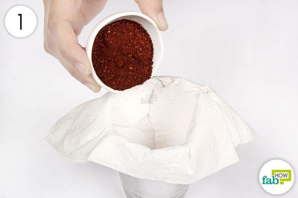 put coffee into a paper towel arranged over a container to brew coffee 
