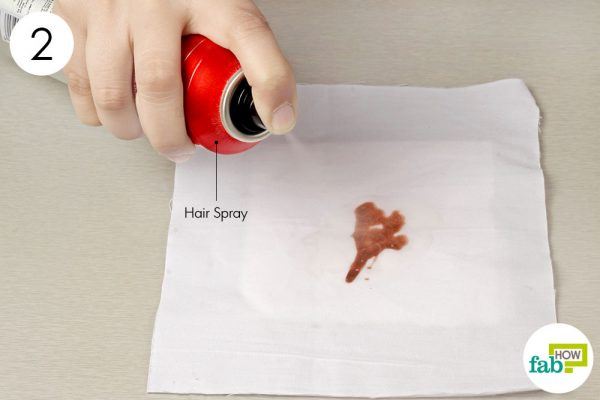 saturate the stain with hair spray 