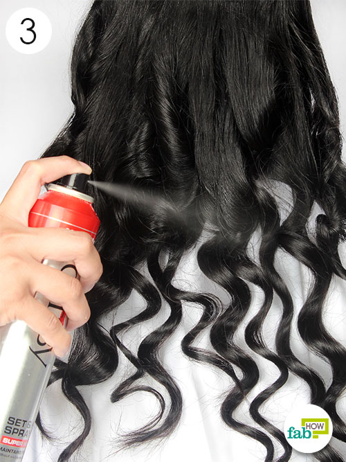 apply a styling spray and opne the curls with fingers