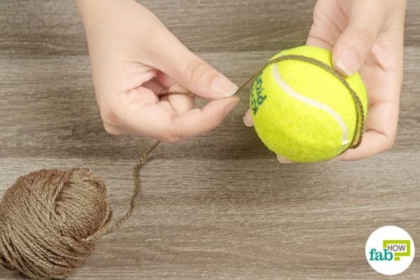 Wrap wool yarn over a tennis ball for dryer laundry hack